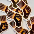 Stickers with raised fist design on a light gray background
