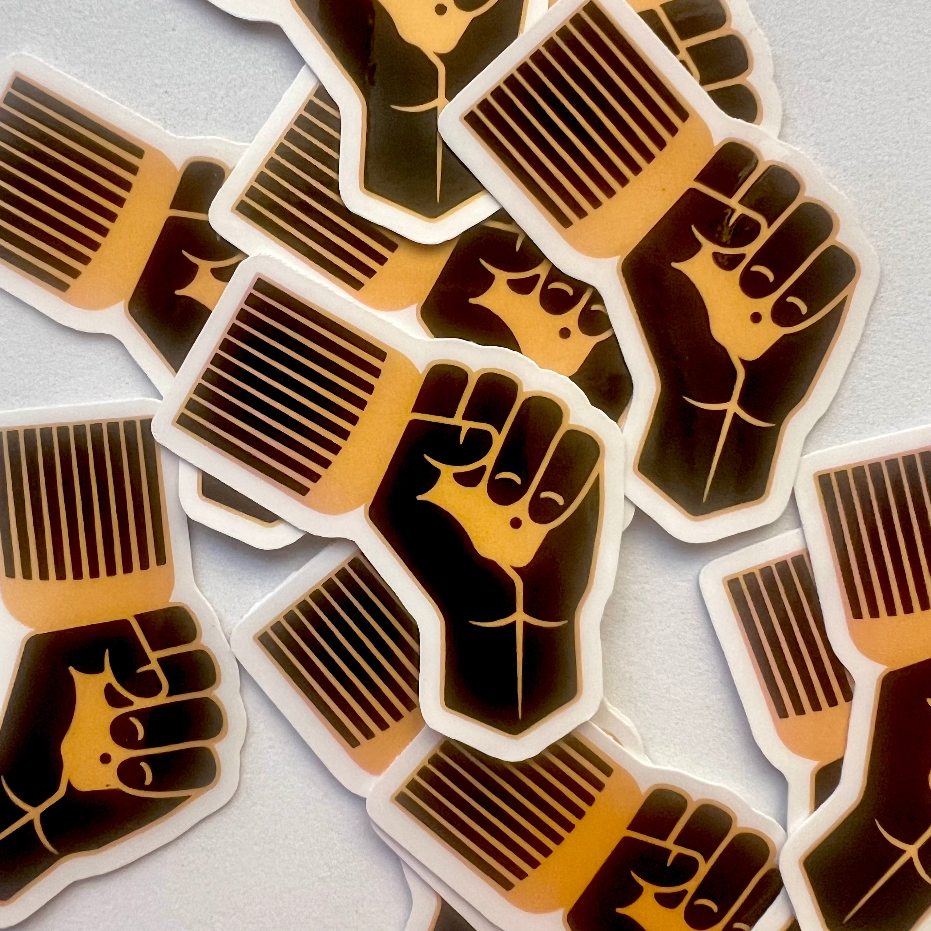 Stickers with raised fist design on a light gray background