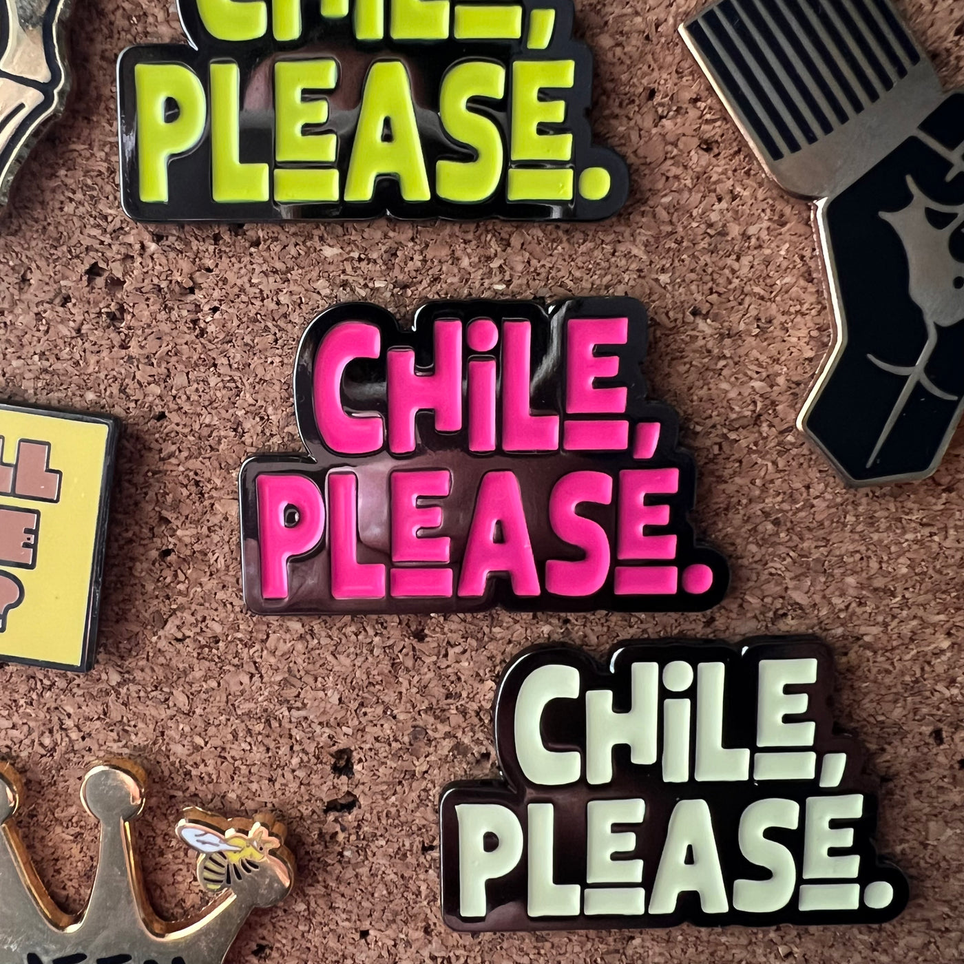 Collection of 'Chile, Please.' themed pins on a cork board background.