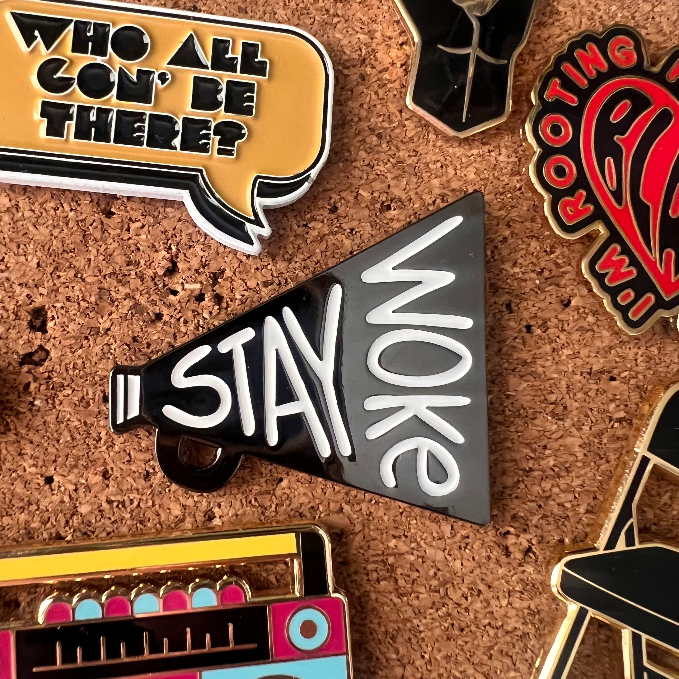 Collection of pins with various designs on a cork board background