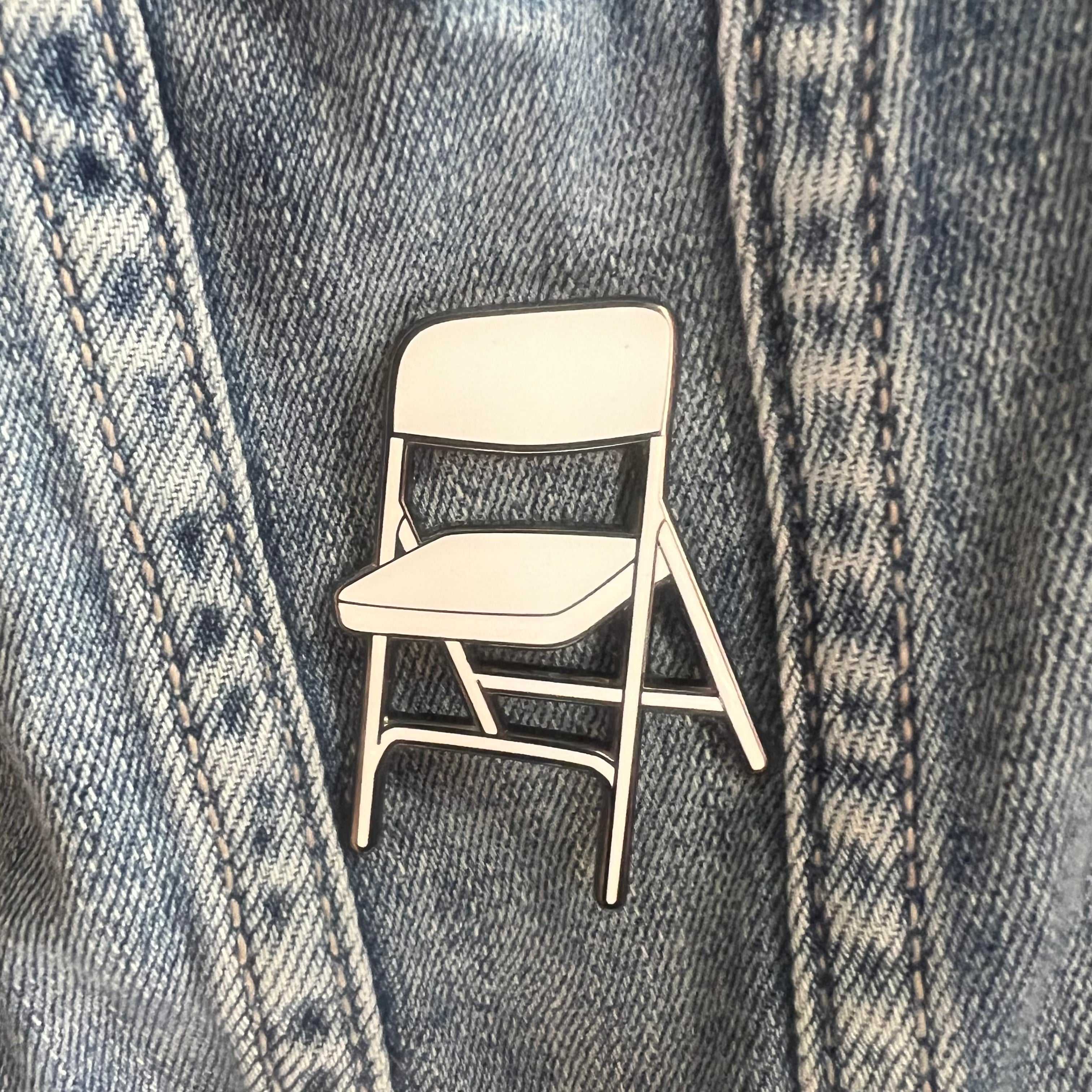Chair-shaped pin on a denim jacket