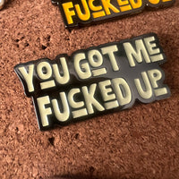 Pin with text 'YOU GOT ME FUCKED UP' on a cork background